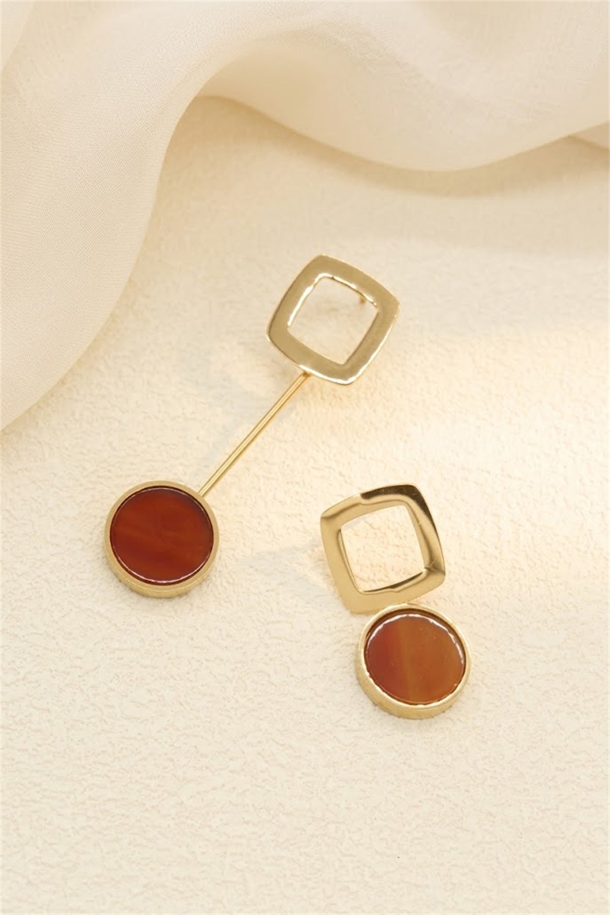 Boucles d'oreilles asymétriques dorées carré ajouré et pierre rouge orangé