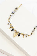 Bracelet tressé noir et doré perles cristal et charm cœur doré