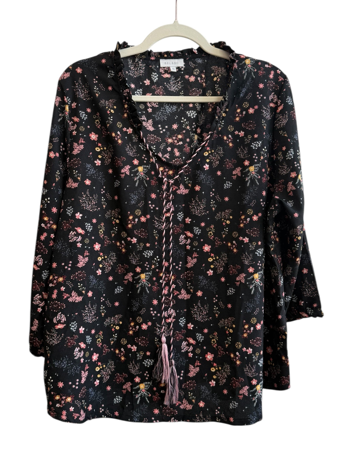ReTrend BEL&BO black floral print blouse, size 46. Features a fluid cut, ruffled collar, and tie-neck with tassels. 100% polyester.