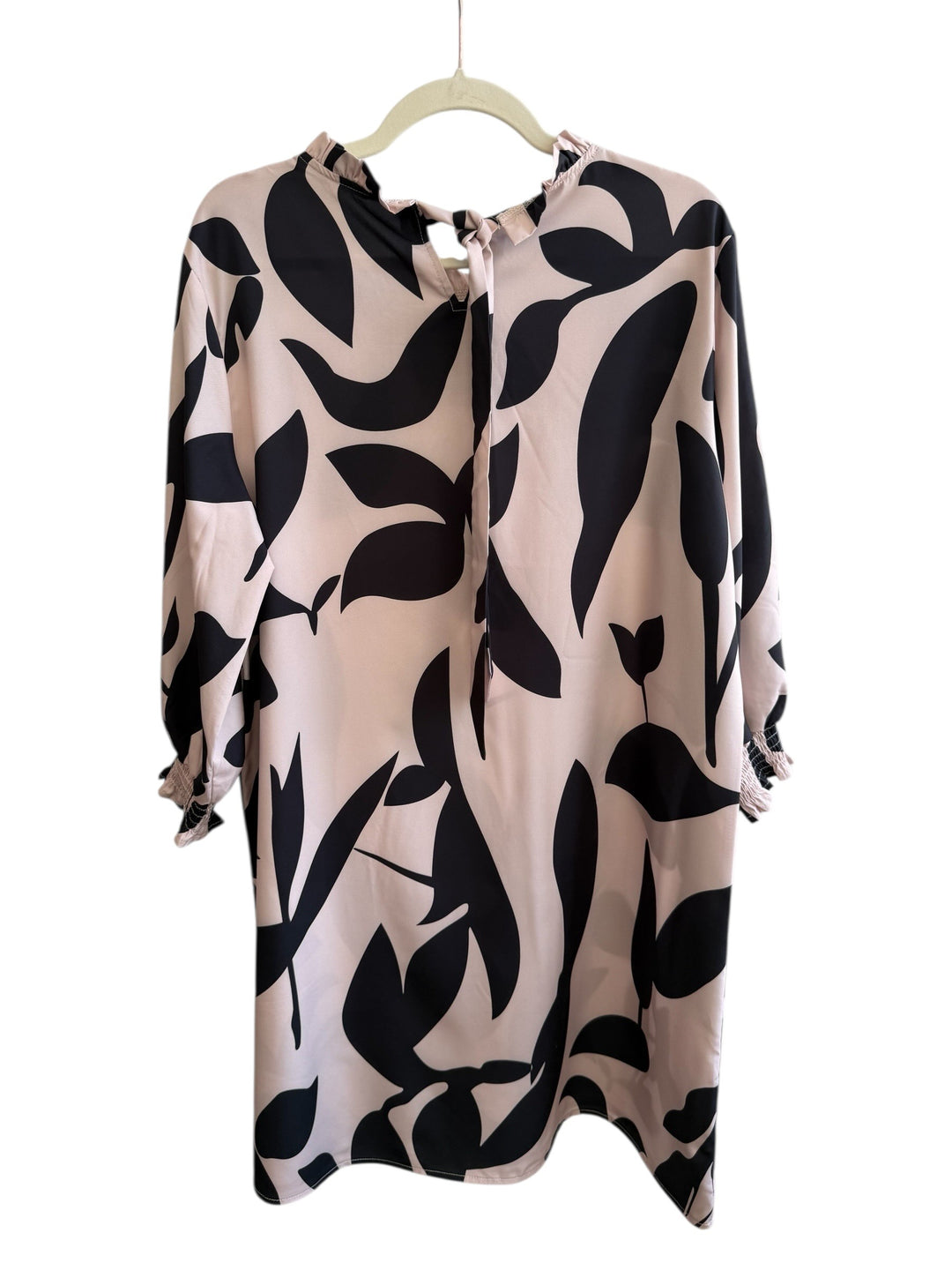 Retrend beige dress with black leaf print, size XL. Features a high neck with ruffle, long sleeves with smocked cuffs, and a flowing straight cut.