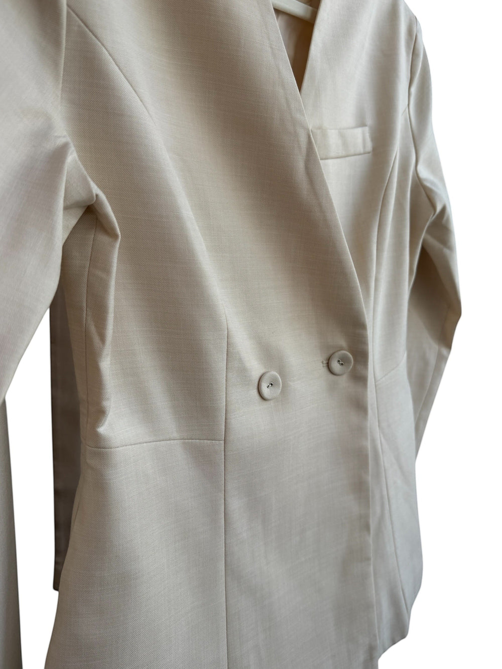 ReTrend beige fitted blazer with a cross-over button closure, notched lapels, and a chest pocket. Size S.