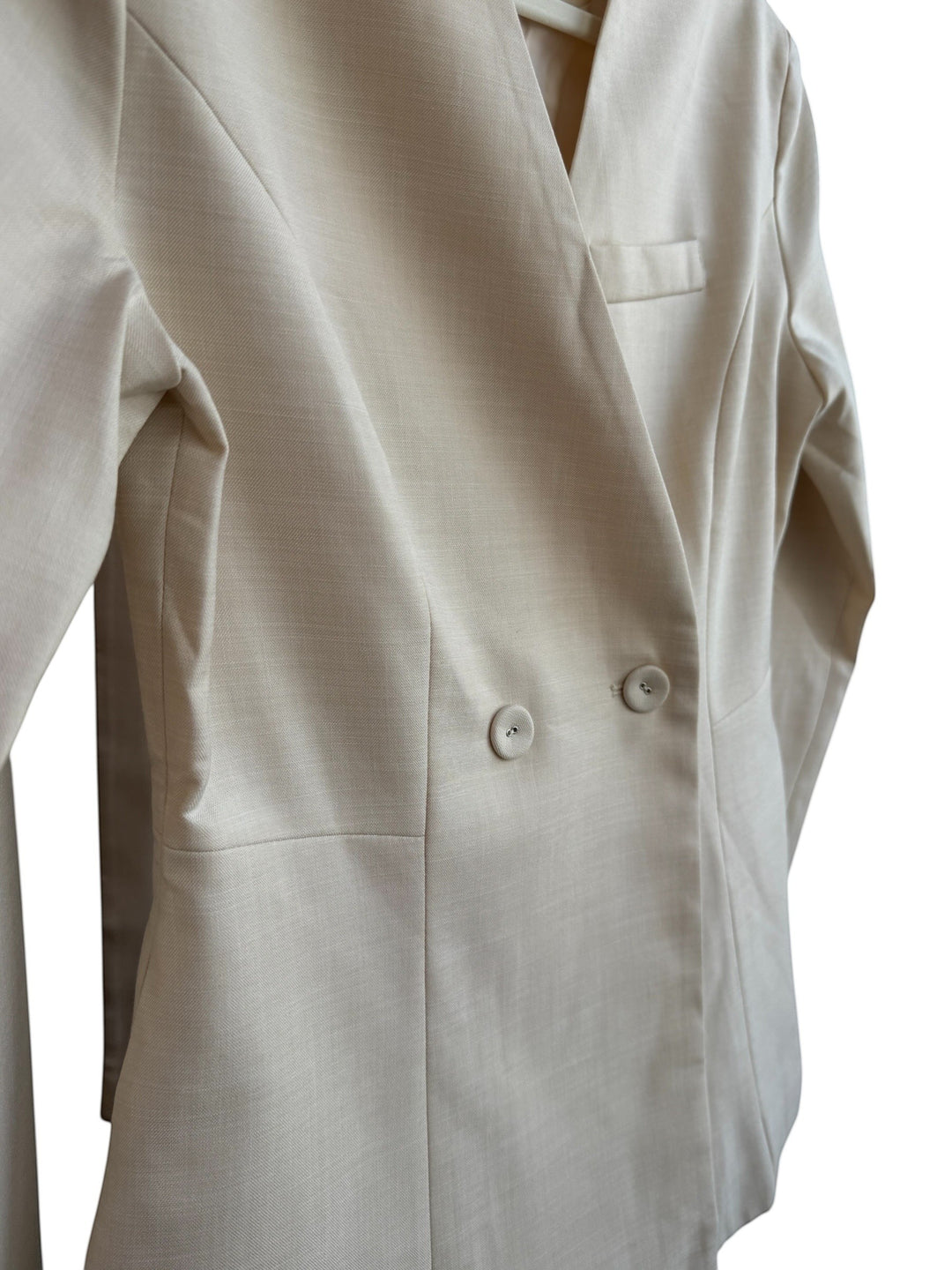 ReTrend beige fitted blazer with a cross-over button closure, notched lapels, and a chest pocket. Size S.