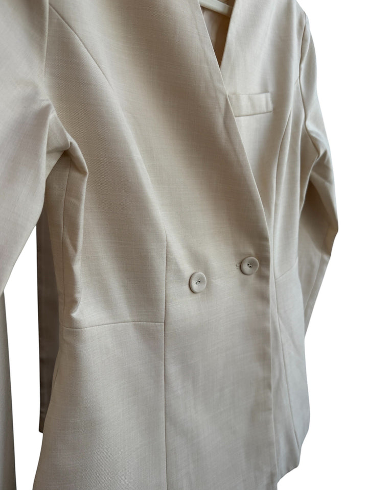 ReTrend beige fitted blazer with a cross-over button closure, notched lapels, and a chest pocket. Size S.