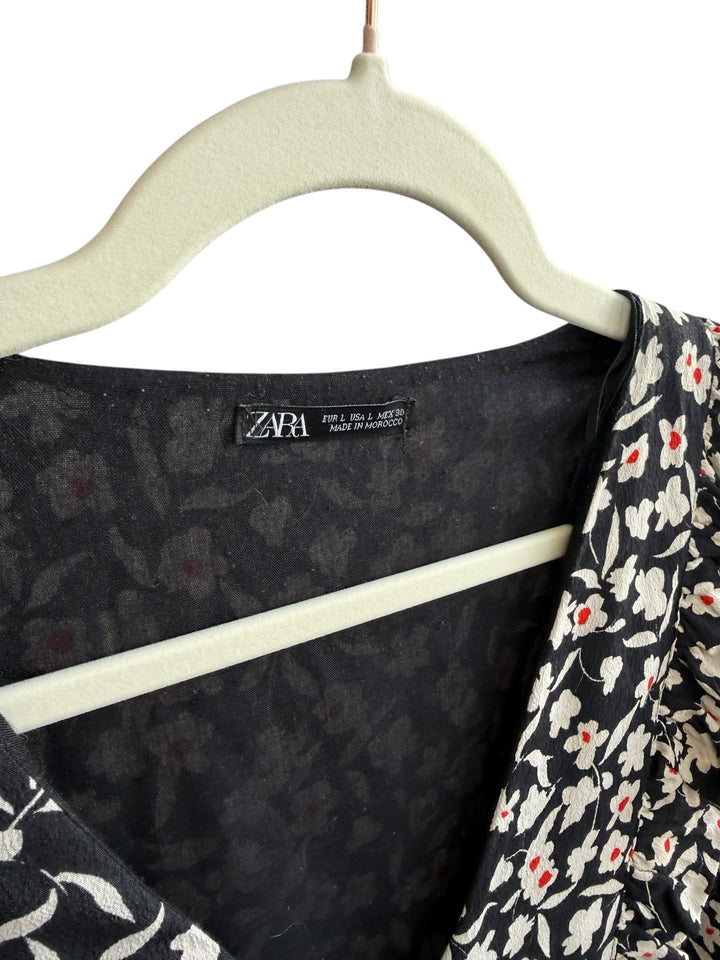 ReTrend black floral print midi dress with white flowers and red accents, size L. Features a V-neck and ruffled details.