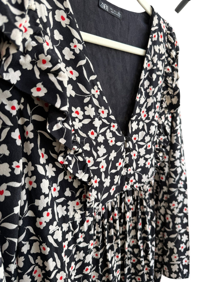 ReTrend black floral print midi dress with white flowers and red centers, V-neck, ruffled details, and long sleeves. Size L.