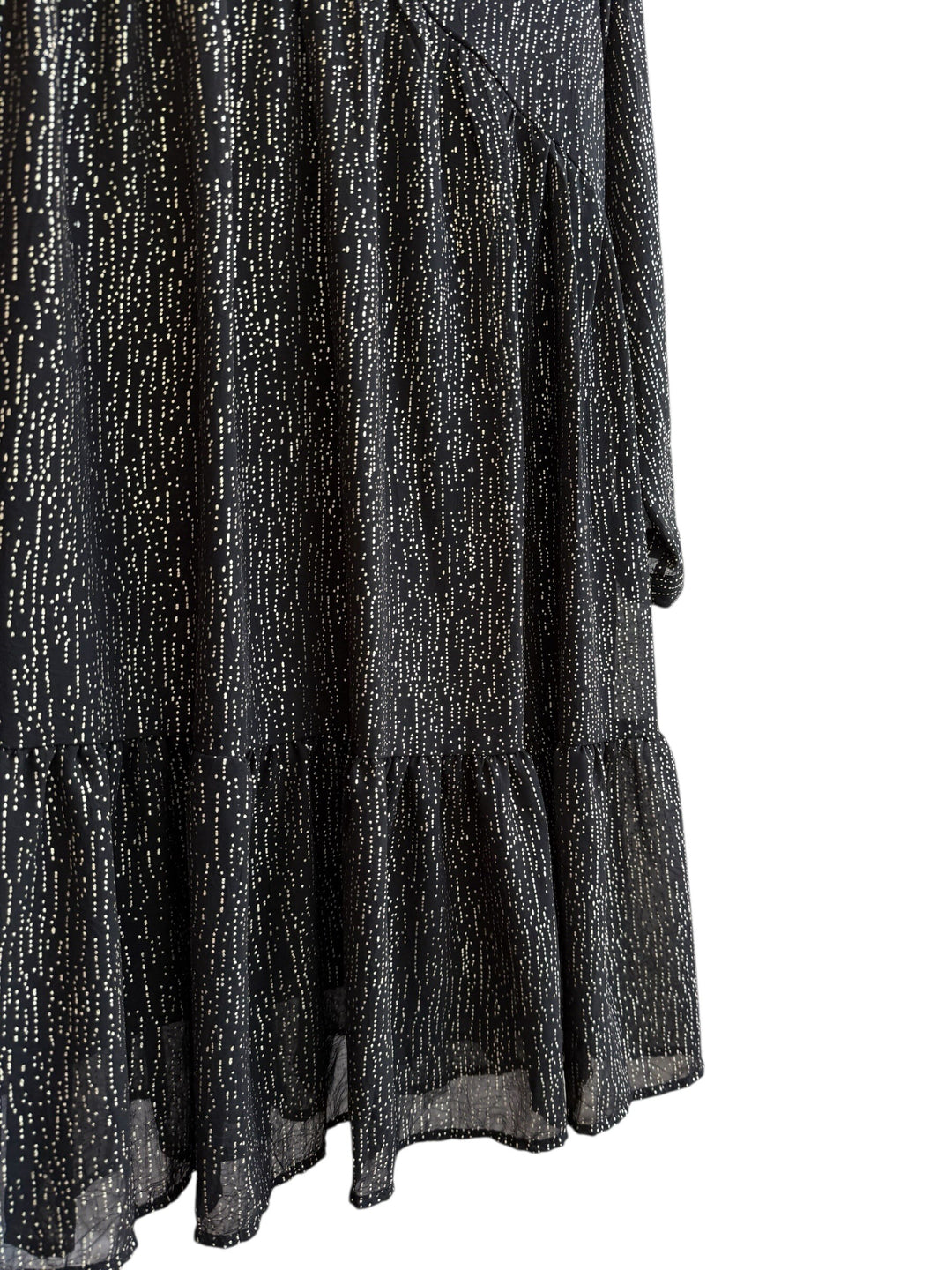 Retrend black fluid dress with subtle gold dotted print, V-neck, empire waist, long sleeves, and tiered hem.