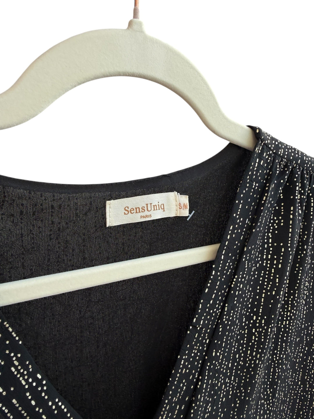 ReTrend black fluid dress with subtle gold dotted print, V-neck, empire waist, long sleeves, and ruffled hem. Size S/M.