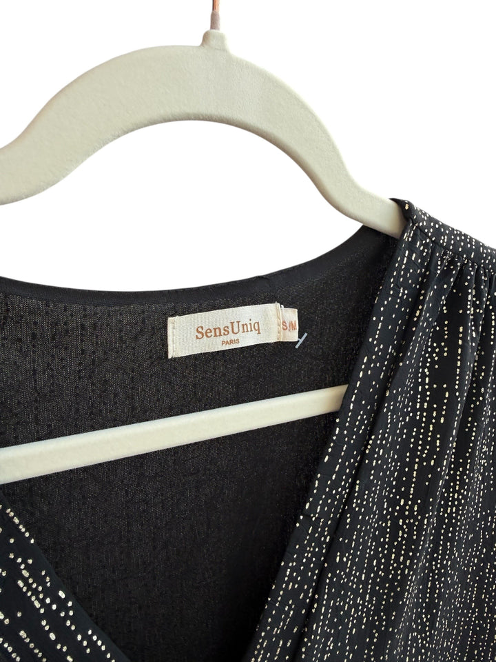 ReTrend black fluid dress with subtle gold dotted print, V-neck, empire waist, long sleeves, and ruffled hem. Size S/M.