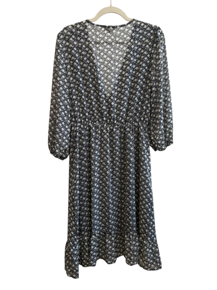 Retrend black and ecru graphic print midi dress with a wrap neckline, 3/4 sleeves, and ruffled hem. Size M.