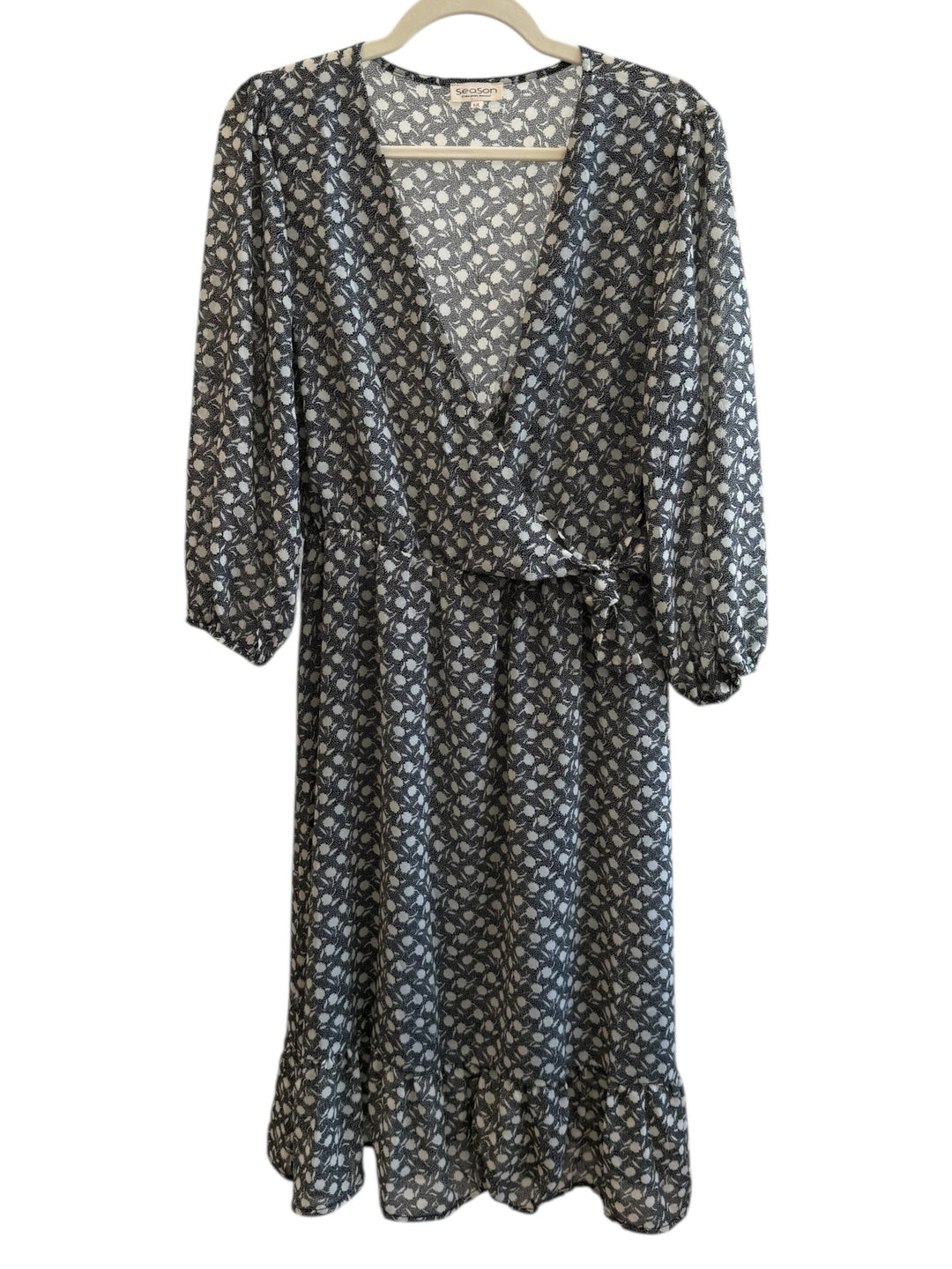 ReTrend black and ecru graphic print wrap dress, size M, with 3/4 sleeves and ruffled hem.