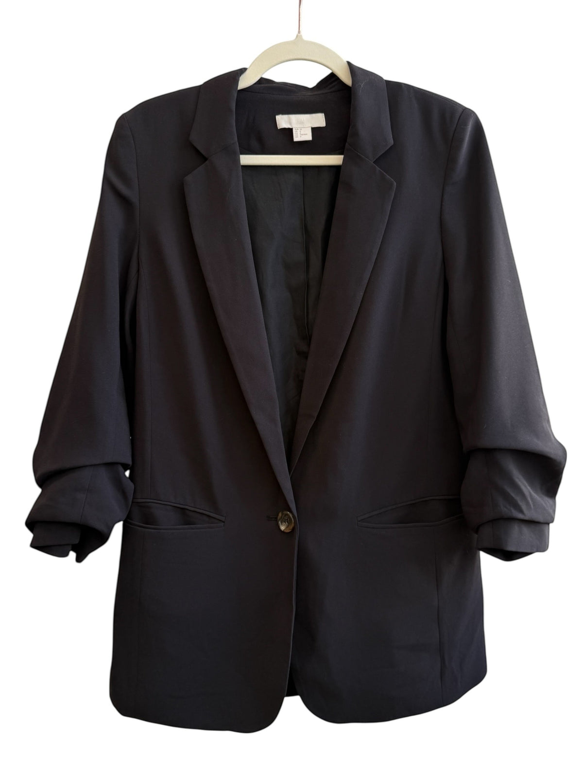 ReTrend black H&M blazer, size 36, slightly oversized fit with cuffed sleeves and flap pockets.