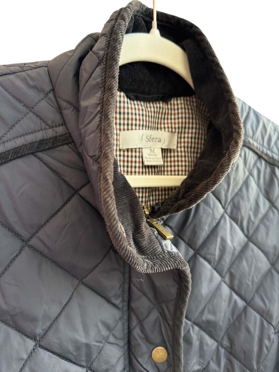Retrend black quilted jacket with corduroy collar and velvet details, size M. Features zip and snap closure, zip pockets, and a checked lining.