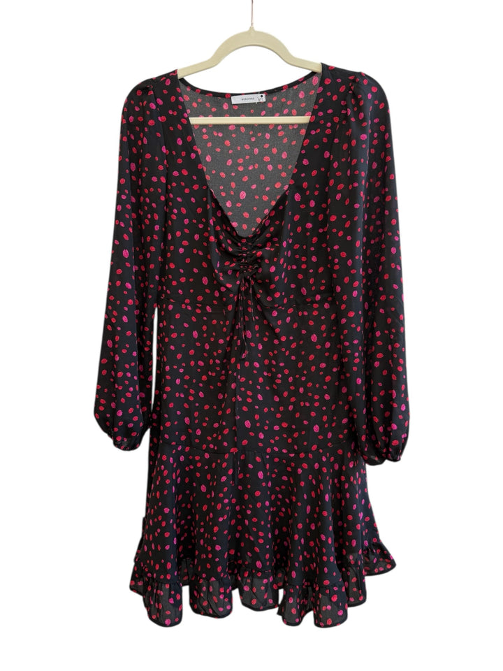 ReTrend black and red polka dot dress size 36. Flowy fabric with deep V-neck, tie detail, long sleeves, and ruffled hem.