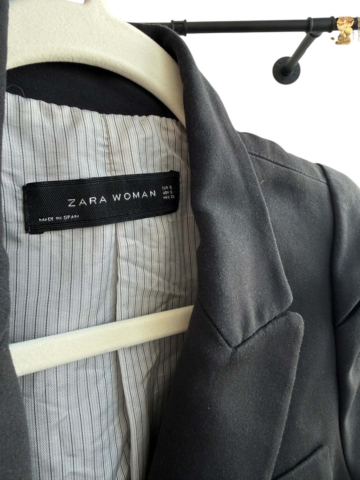 ReTrend black tailored blazer with structured shoulders and pinstripe lining. Classic lapel collar, button closure, and flap pockets.