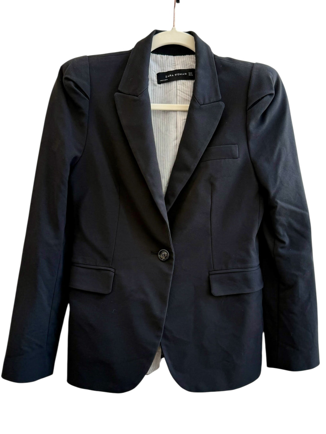 ReTrend black tailored blazer with structured shoulders, single button closure, and flap pockets. Lined with pinstripes.