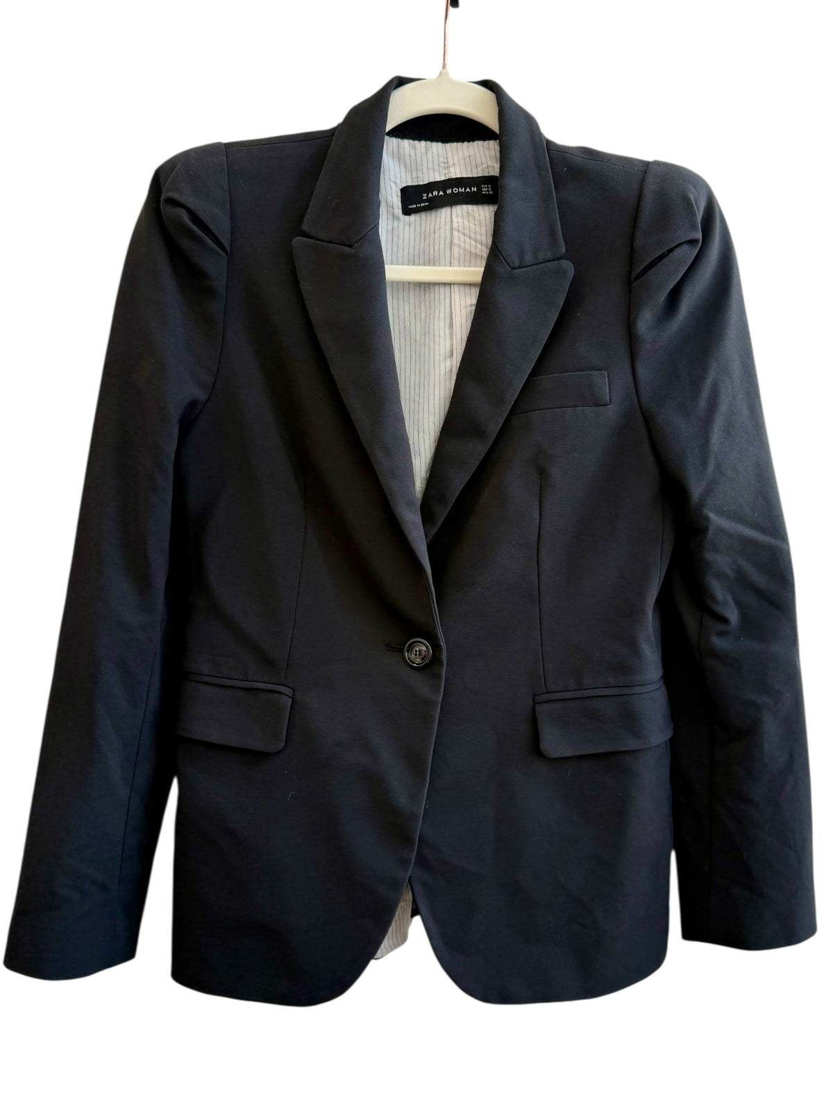 ReTrend black tailored blazer with structured shoulders, single button closure, and flap pockets. Lined with pinstripes.