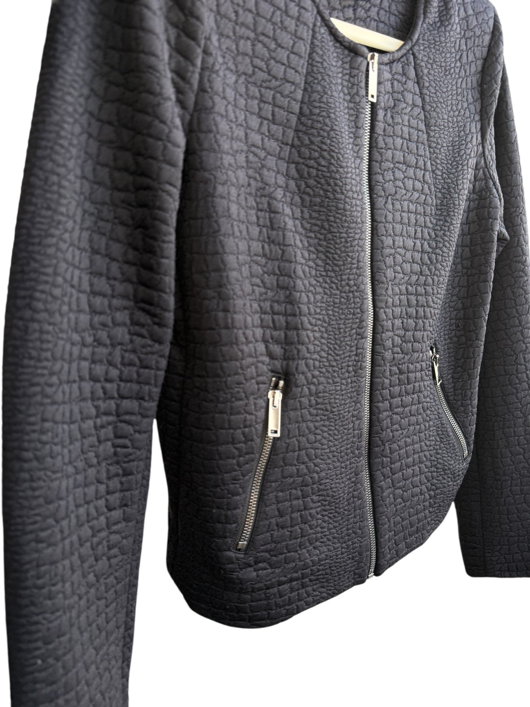 ReTrend black textured jacket, size M. Modern, structured, short cut with round neck and zip closure. Features zip pockets and unique relief texture.