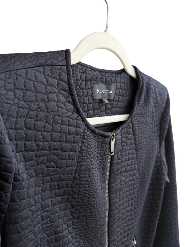 ReTrend black textured Kocca jacket, size M. Modern structured design with a round neck, zip closure, and textured fabric.