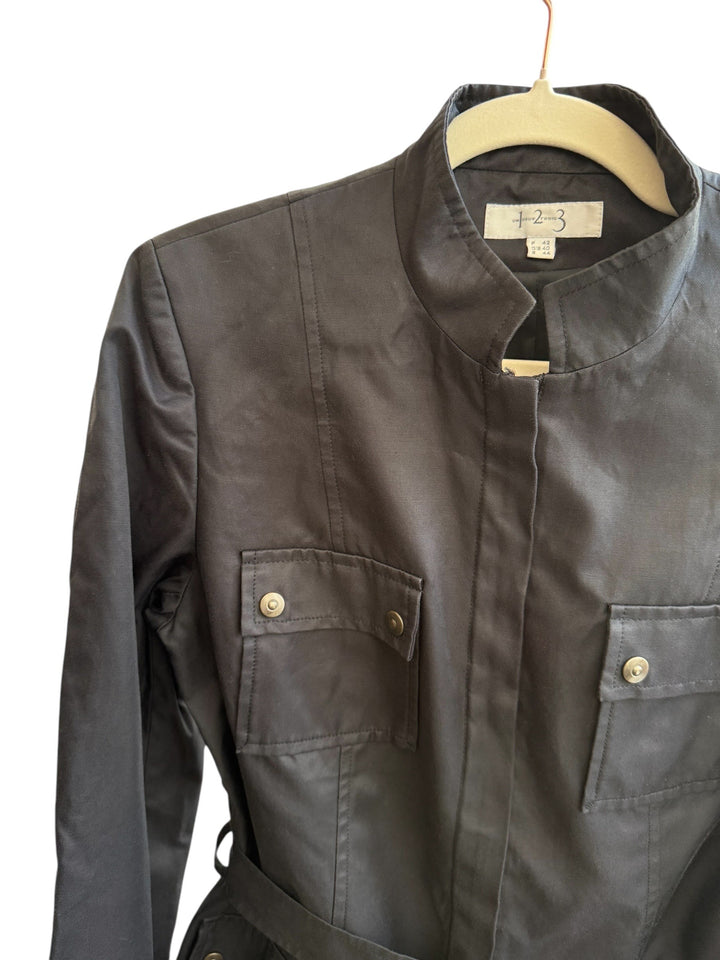 Retrend black structured twill jacket with mandarin collar, discreet button closure, waist belt, and buttoned flap pockets. Size 40.