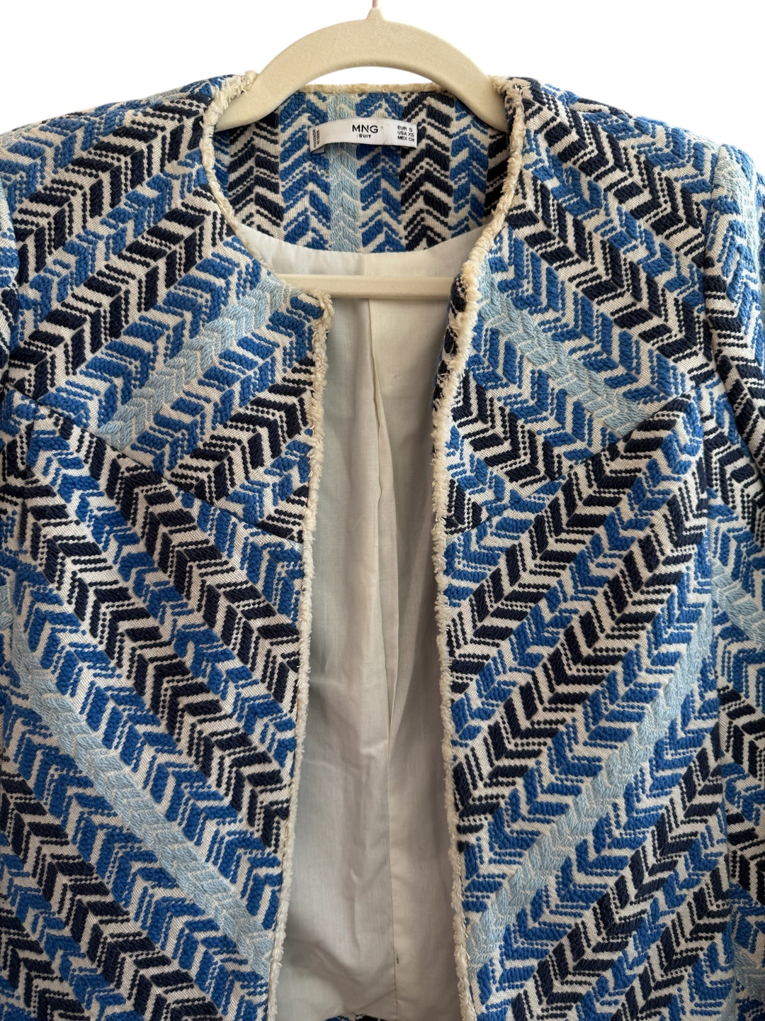 ReTrend blue, white, and black chevron patterned short jacket with fringed trim, made from cotton, linen, and polyamide.