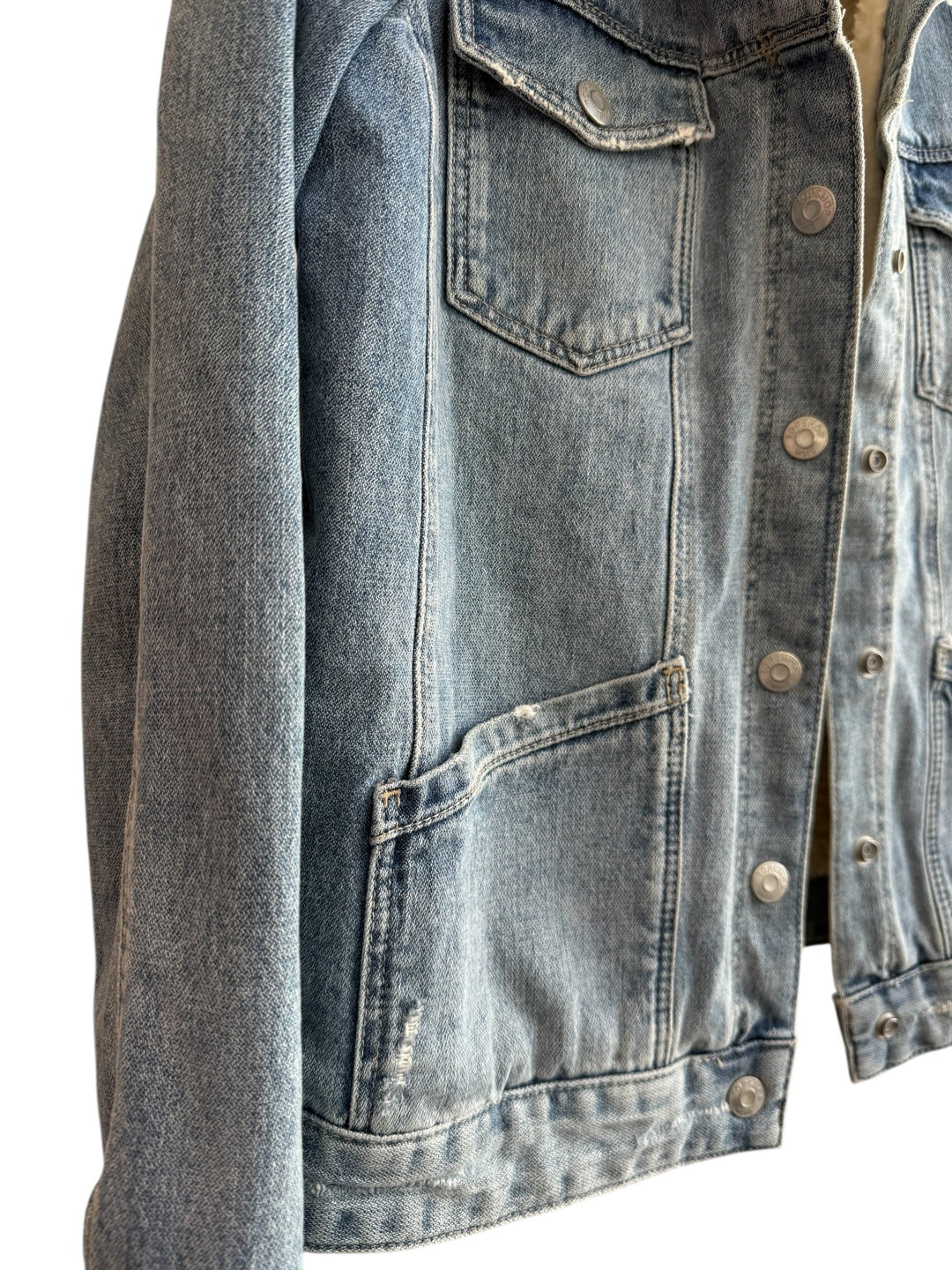 Retrend blue denim jacket with sherpa lining and collar, button closure, chest pockets, and side pockets.