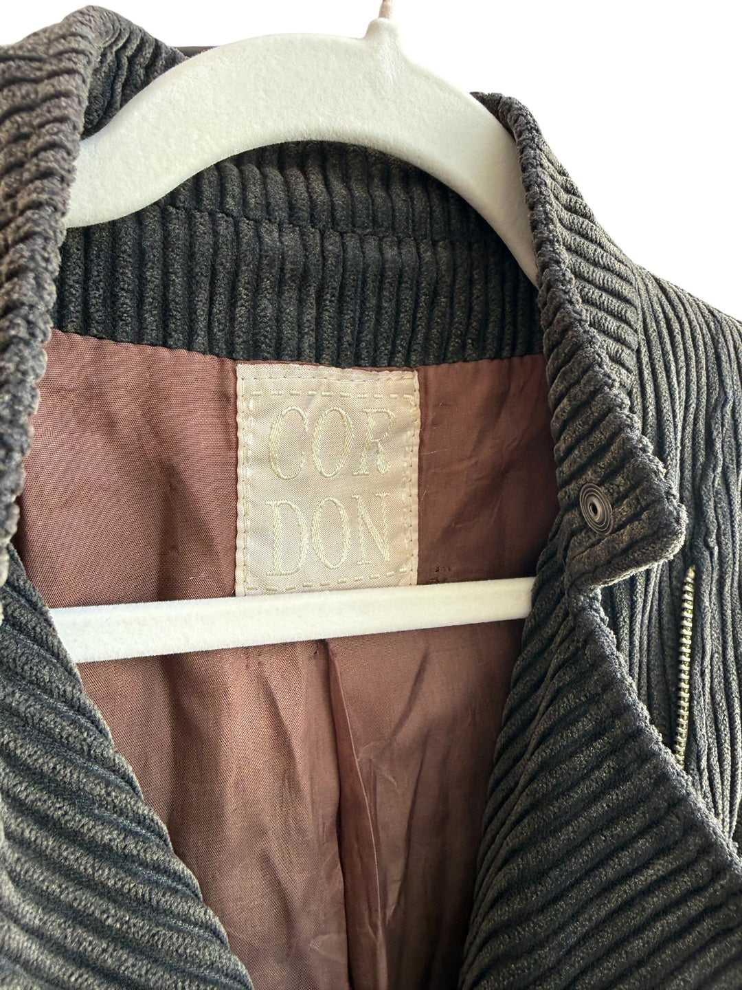 ReTrend brown corduroy jacket with asymmetric zip, structured collar, and zip cuffs. Size 40.