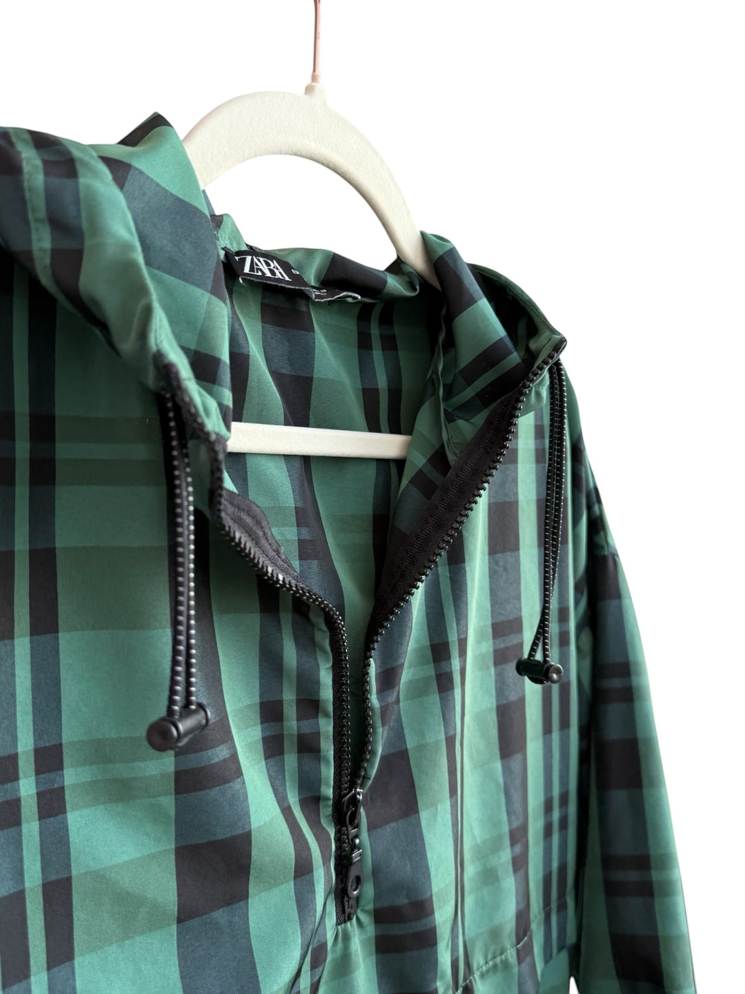 ReTrend green and black plaid lightweight jacket with hood, zip closure, and drawstring hem. Size S.