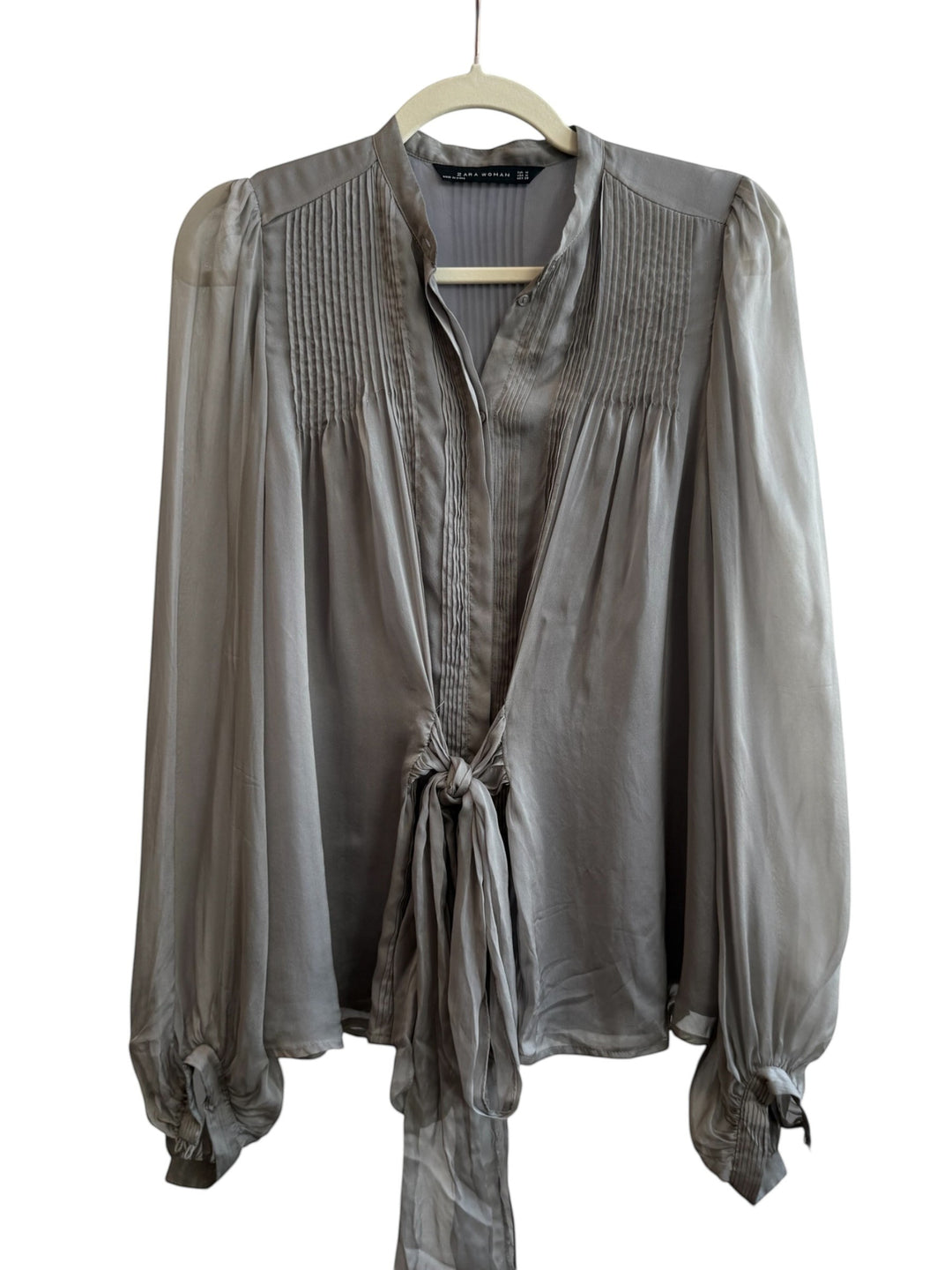 ReTrend grey silk blouse with fluid cut, pleated details, tie front, and puffed sleeves. Size M.