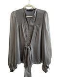 ReTrend grey silk blouse with fluid cut, pleated details, tie front, and puffed sleeves. Size M.
