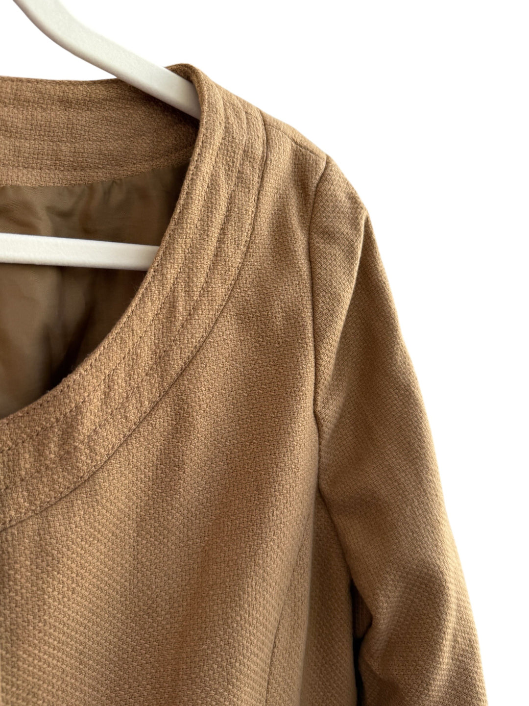 ReTrend H&amp;M camel textured short structured jacket with round neck and button closure.
