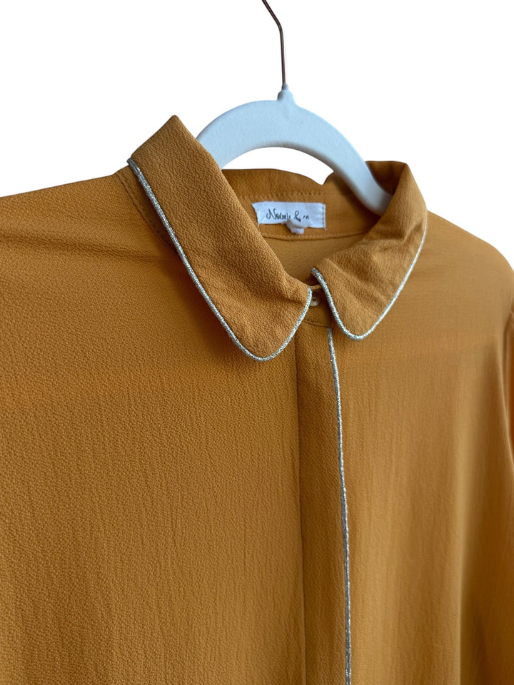 ReTrend mustard yellow polyester blouse with rounded collar, hidden buttons, and silver trim detail. Size L.