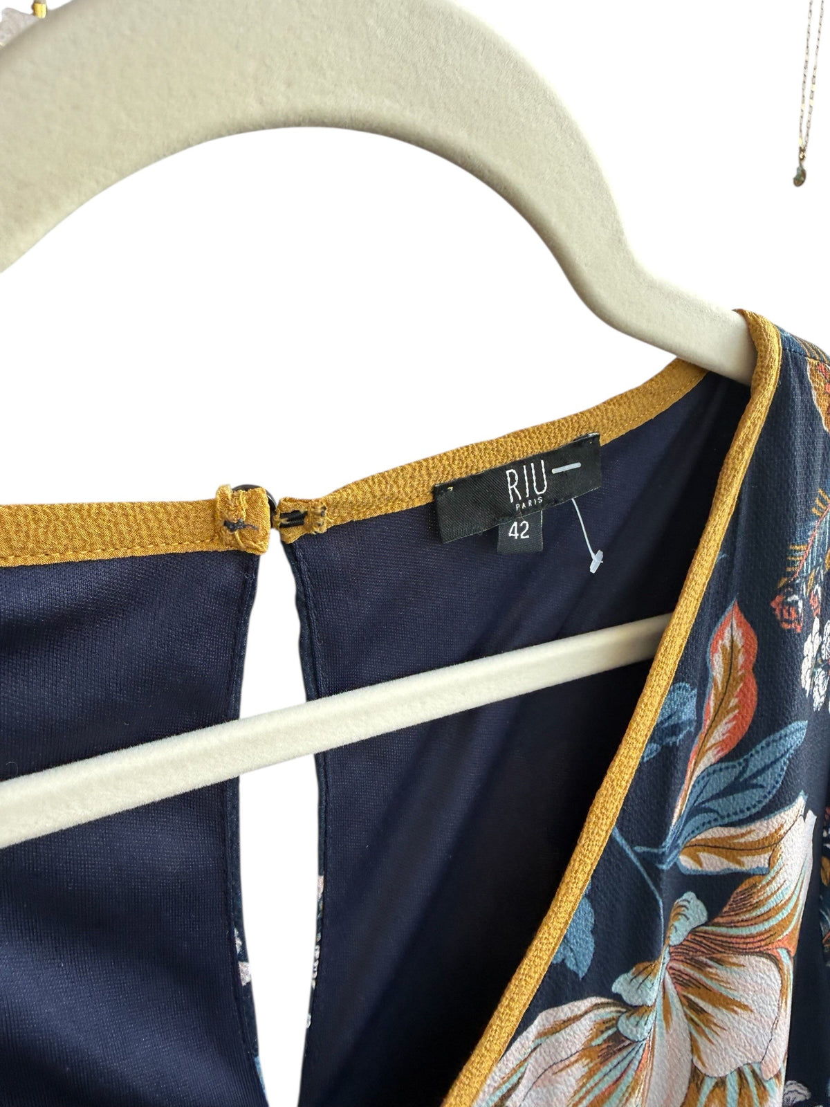 ReTrend navy blue floral print dress, size 42, with warm-toned flowers and a contrasting yellow trim.