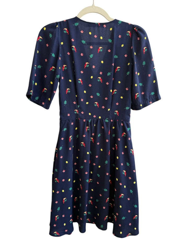 ReTrend navy blue midi dress with toucan, flower, and lemon print. Features V-neck, marked waist, and mid-length sleeves.