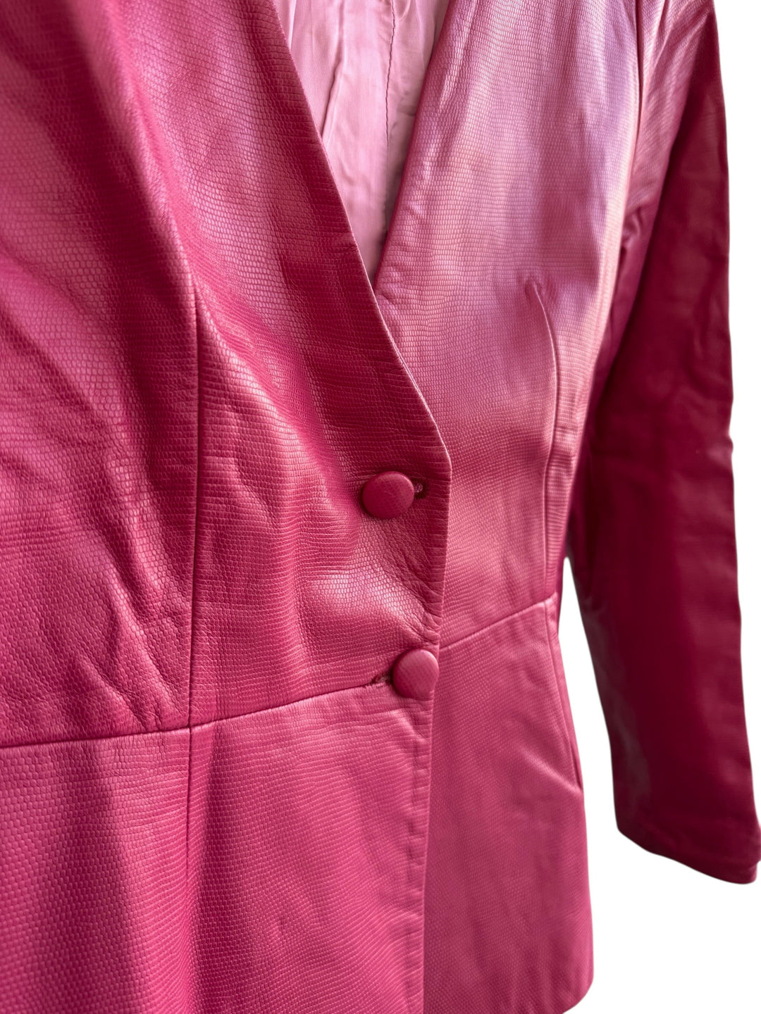 ReTrend raspberry pink 100% leather blazer, size 38. Features a textured finish, fitted cut, and covered button closure.