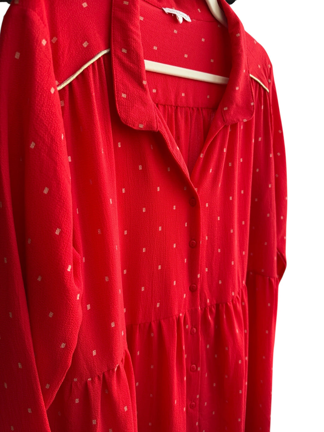 Retrend red flowing dress with small gold dots, button front, long sleeves, and gold trim detail.