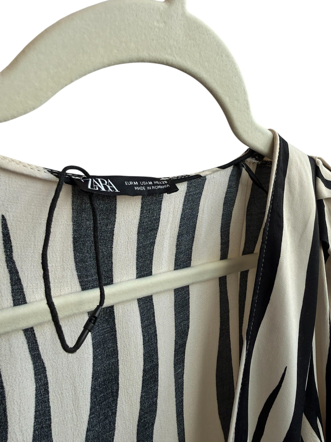 ReTrend Zara beige and black striped wrap dress, size M, with tie waist and side zip. Features integrated shorts.