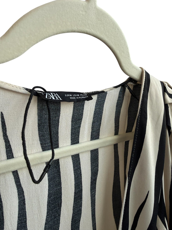 ReTrend Zara beige and black striped wrap dress, size M, with tie waist and side zip. Features integrated shorts.